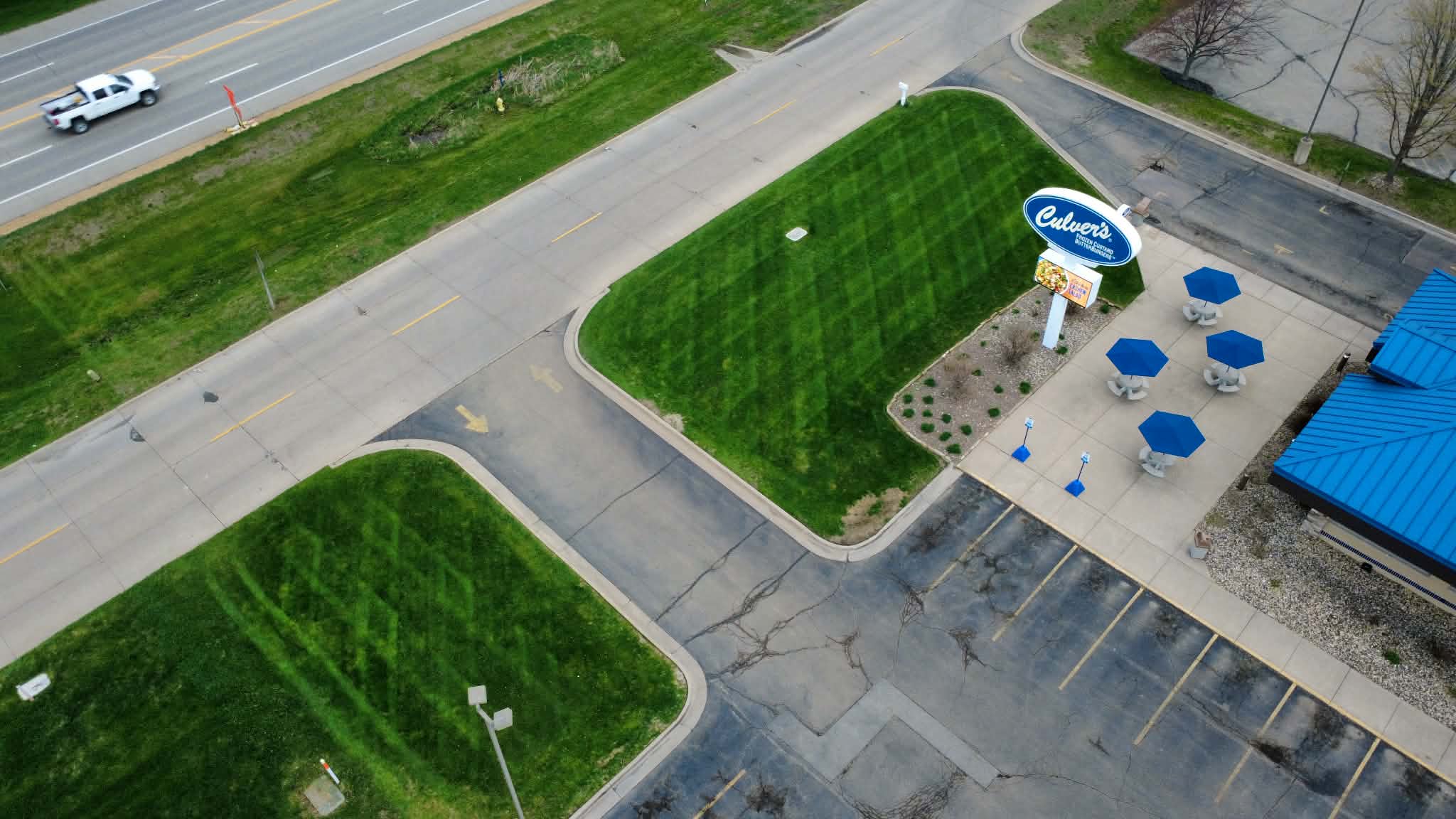 Aerial view of a freshly mowed and striped commercial lawn